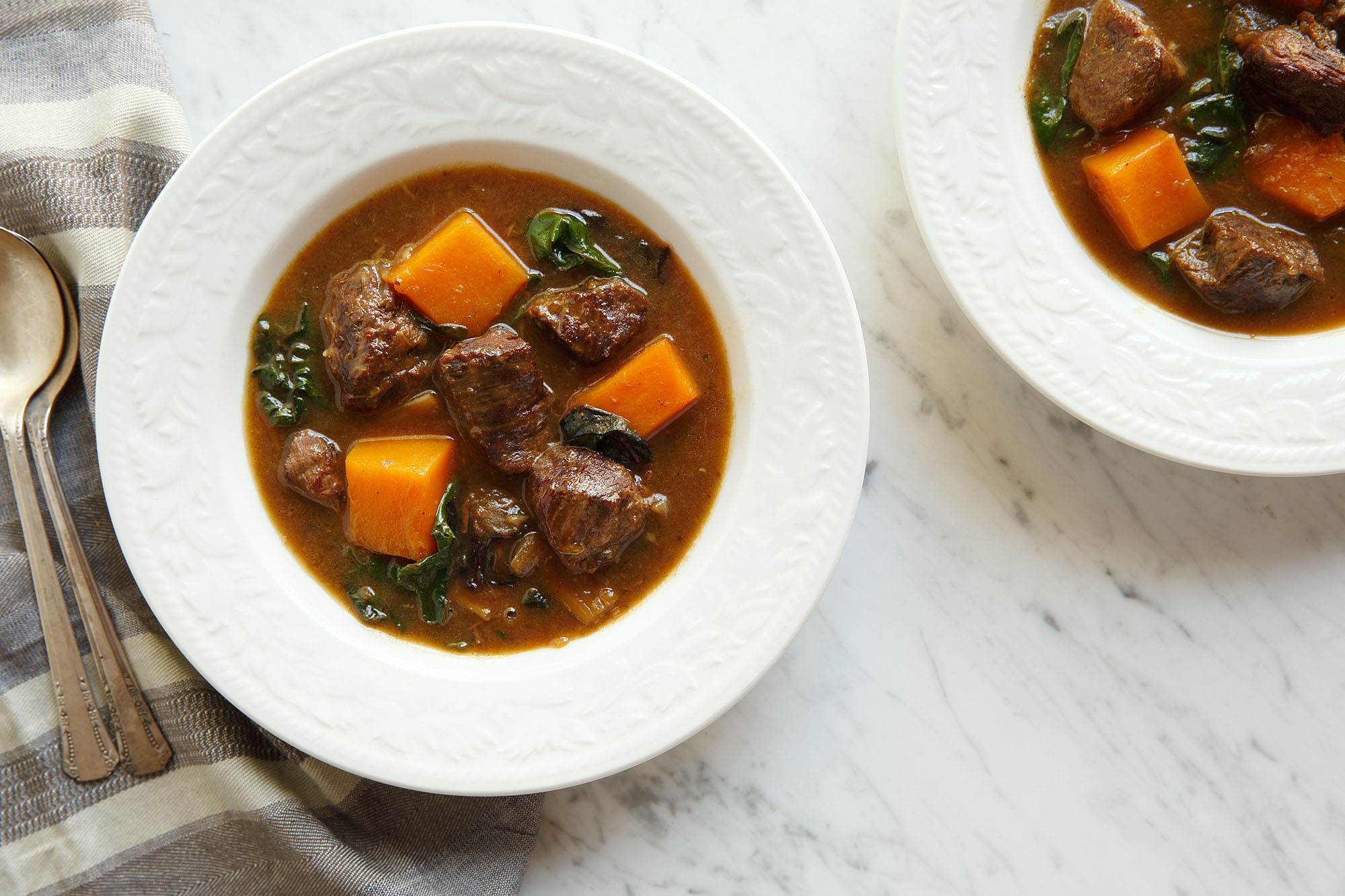 Made with American Lamb stew meat in your slow cooker, it's seasoned with chard, onion, garlic, cardamom and pepper. After cooking for a short time, you add squash, apple cider, a cinnamon stick, bay leaf and cloves to simmer for 6-8 hours. 