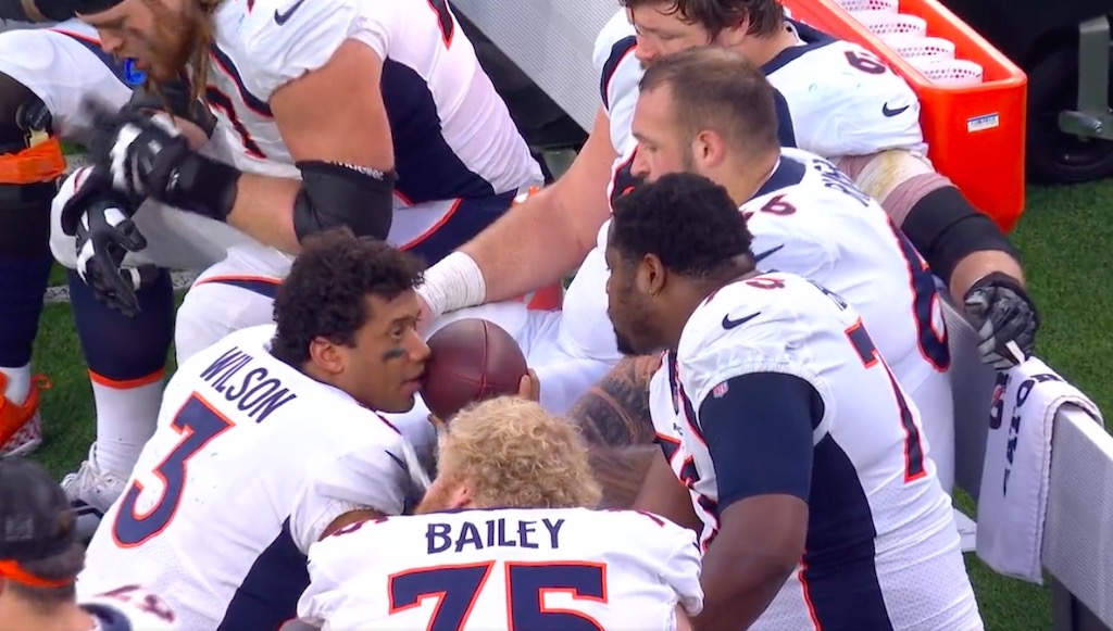 NFL fans had so many jokes about Russell Wilson talking to teammates with a football near his mouth