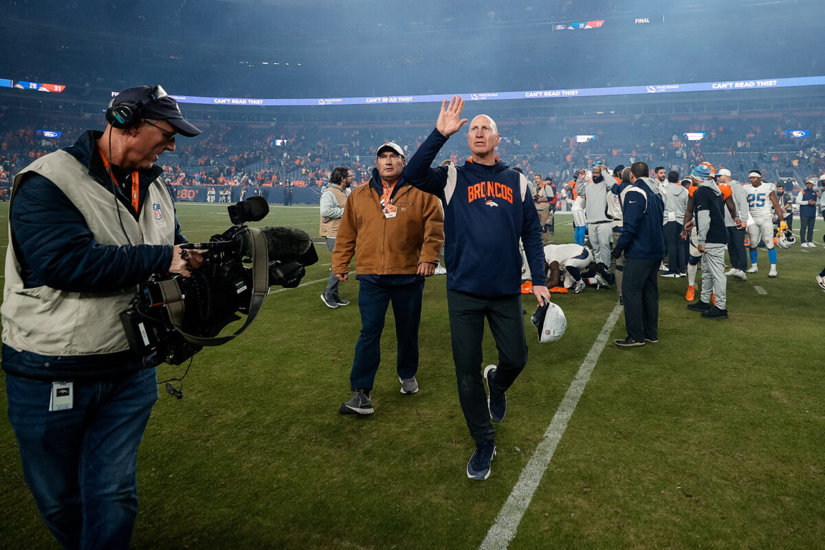 Broncos owner Greg Penner gave Jerry Rosburg a game ball after Sunday’s win