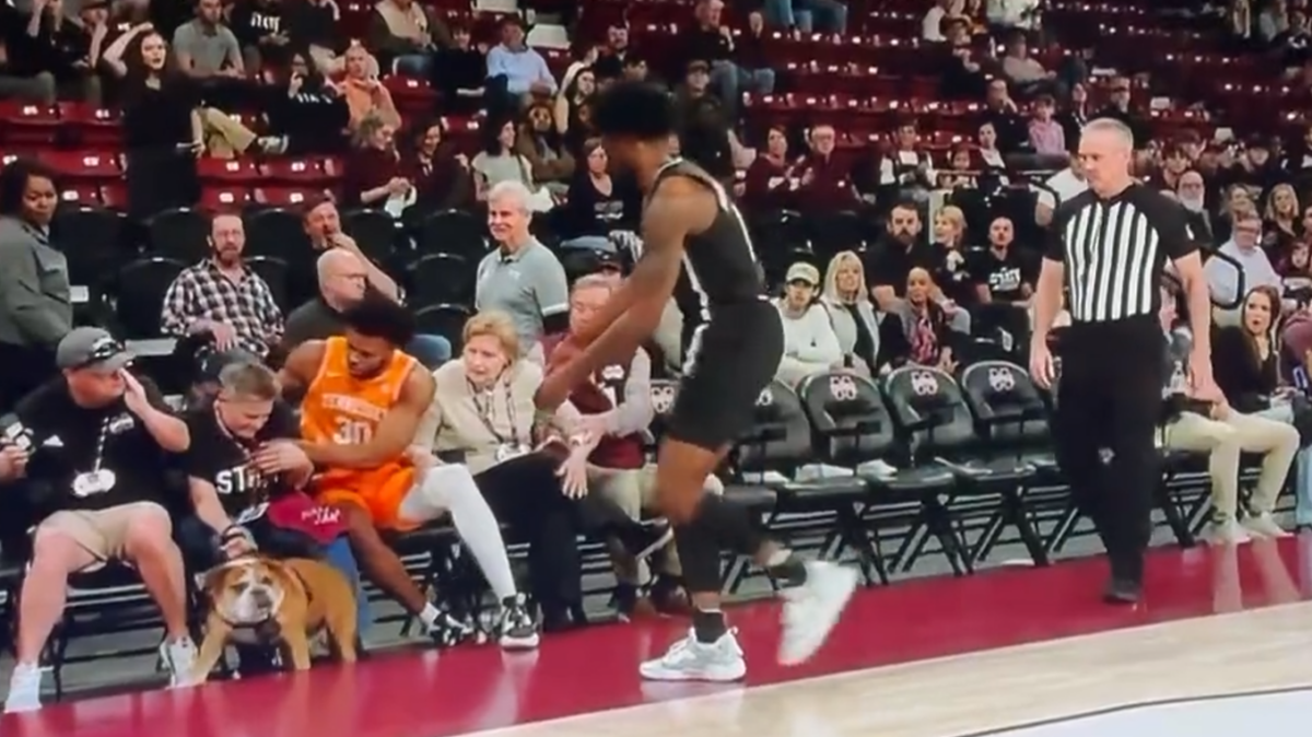 Tennessee’s Josiah-Jordan James nearly collided with Mississippi State’s Bully the dog while both lunged for basketball