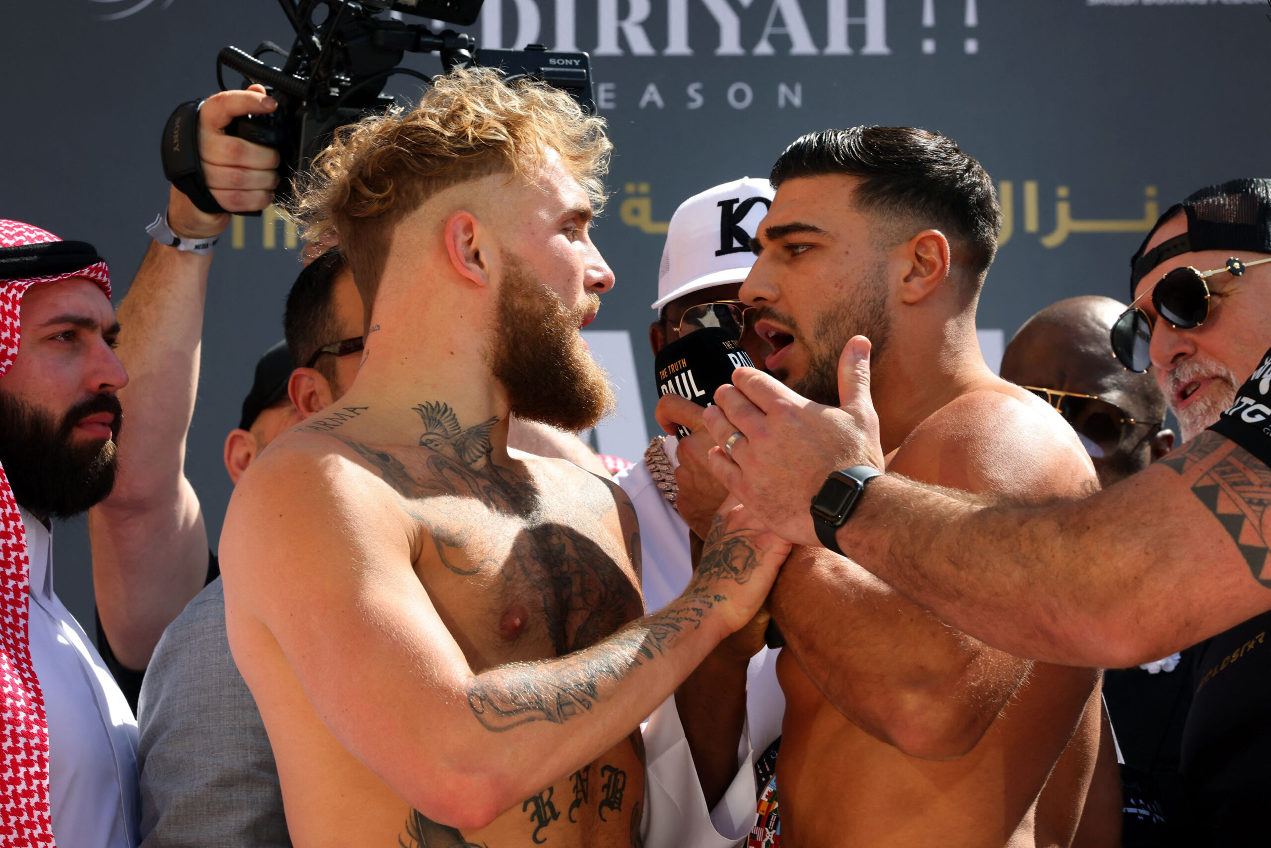 Video: Jake Paul, Tommy Fury hurl profanities at each other during weigh-in faceoff – and there’s a shove