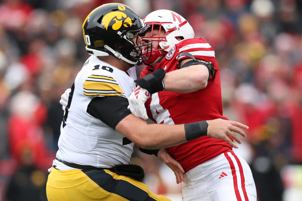 Iowa’s Deacon Hill pitches football while falling to avoid safety