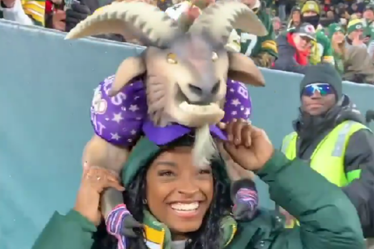 Simon Biles receiving a GOAT hat from a Packers superfan is a delightful treat