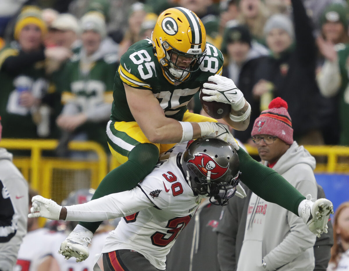 Packers TE Tucker Kraft hurdles a defender and gets hit in a sensitive place