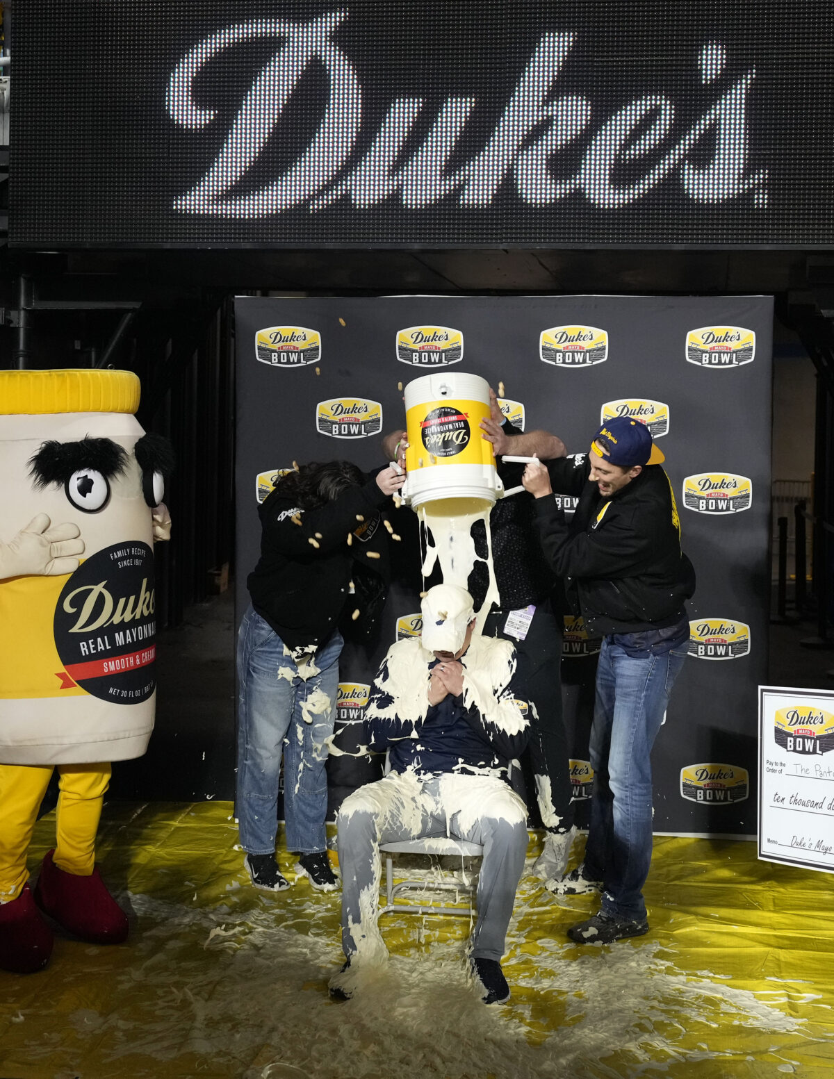 West Virginia coach Neal Brown gets doused with Duke’s Mayo after bowl win