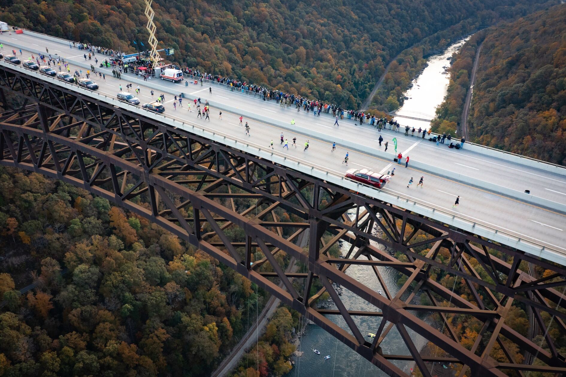 Runners crossing over a bridge at West Virginia's New River Gorge National Park during a race.