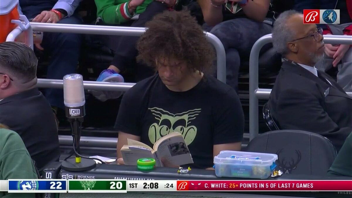 An unemployed Robin Lopez sat courtside and read a book during a game after the Bucks traded him