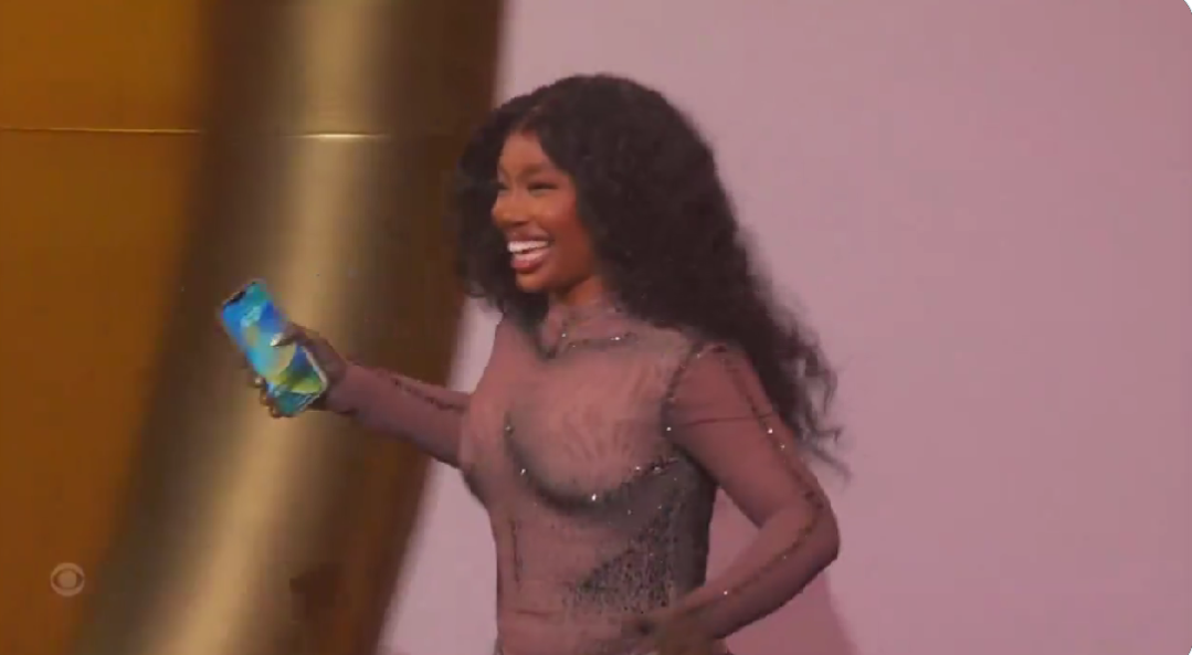 SZA delightfully rushed to the stage carrying her phone to accept Grammy award