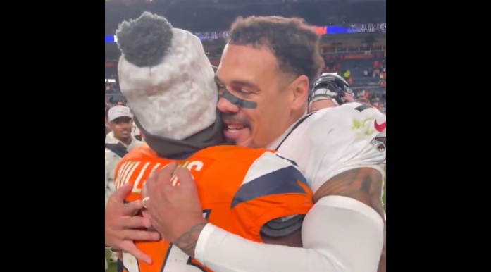 Broncos players lined up to hug Justin Simmons after beating Falcons